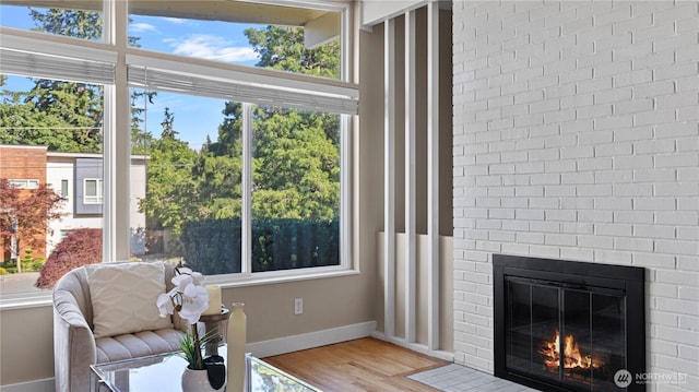 3953 153rd Ave SE, Bellevue, WA 98006 - sitting room featuring a brick fireplace, wood finished floors, and baseboards
