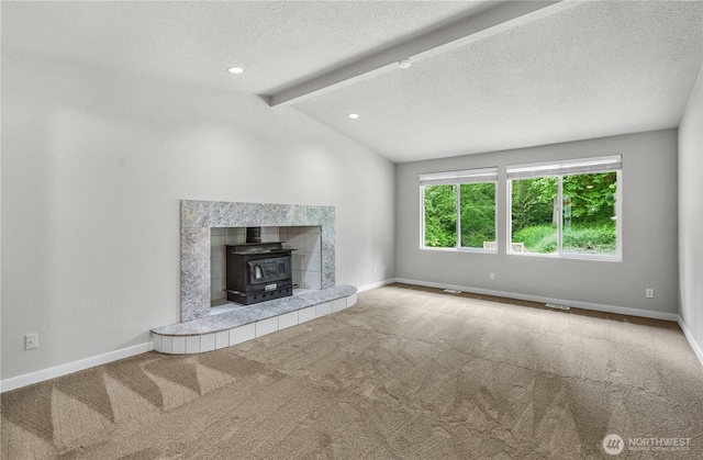 15828 3rd Ave SE, Bothell, WA 98012 - unfurnished living room featuring carpet, a wood stove, a textured ceiling, and baseboards