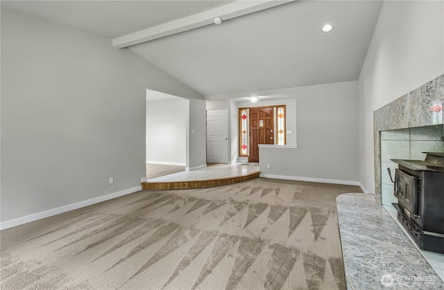 15828 3rd Ave SE, Bothell, WA 98012 - unfurnished living room with a wood stove, carpet flooring, beam ceiling, baseboards, and high vaulted ceiling