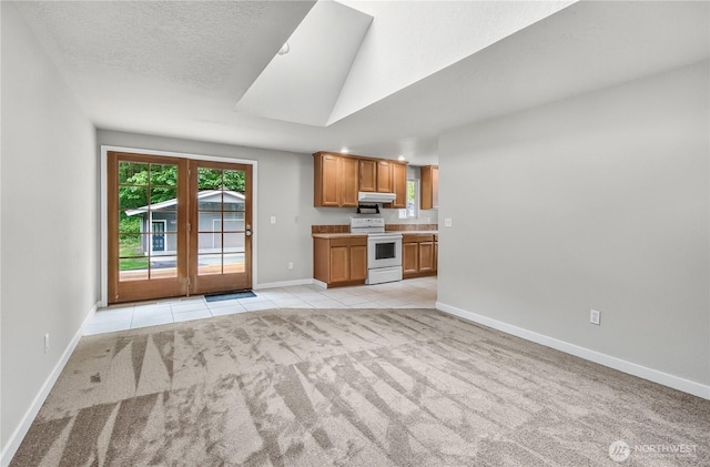 15828 3rd Ave SE, Bothell, WA 98012 - kitchen with white range with electric stovetop, light colored carpet, baseboards, brown cabinets, and a textured ceiling