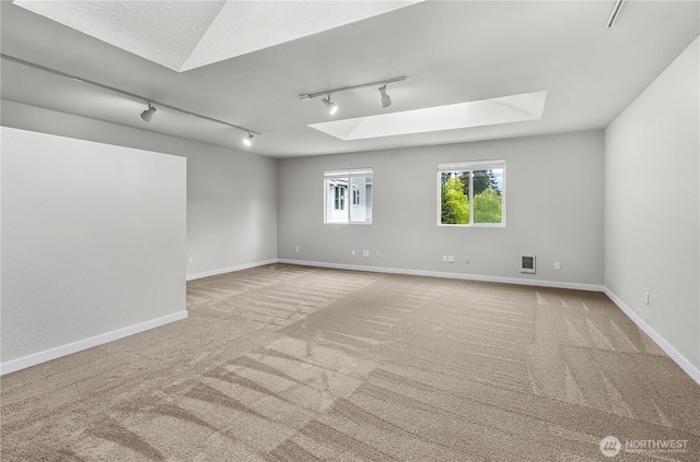 15828 3rd Ave SE, Bothell, WA 98012 - spare room featuring track lighting, a skylight, and carpet flooring