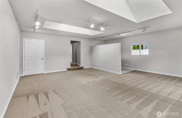 15828 3rd Ave SE, Bothell, WA 98012 - carpeted empty room featuring rail lighting, a skylight, and baseboards