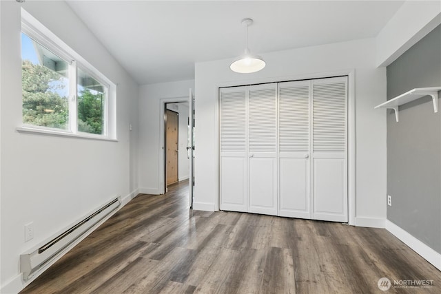 415 Snow Mass Ln, Yakima, WA 98908 - unfurnished bedroom with a baseboard heating unit, wood finished floors, a closet, and baseboards