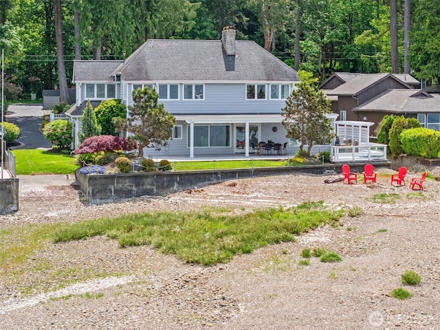 11521 E State Route 106, Union, WA 98592 - back of property with a chimney, a patio, and roof with shingles