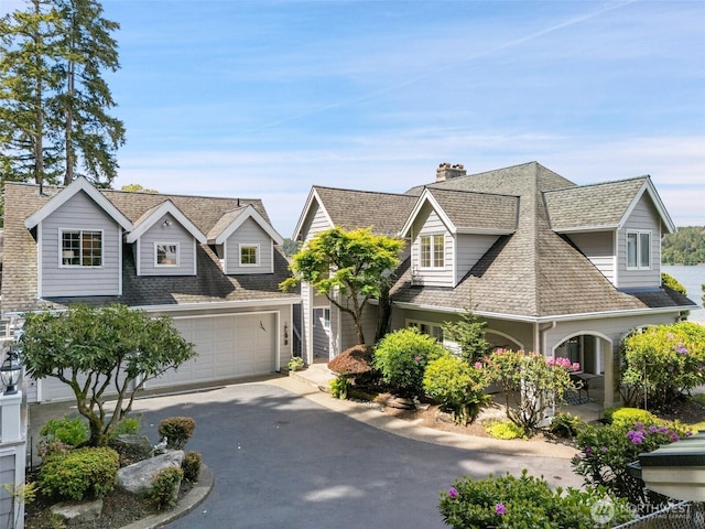 11521 E State Route 106, Union, WA 98592 - shingle-style home featuring driveway, a shingled roof, and a garage