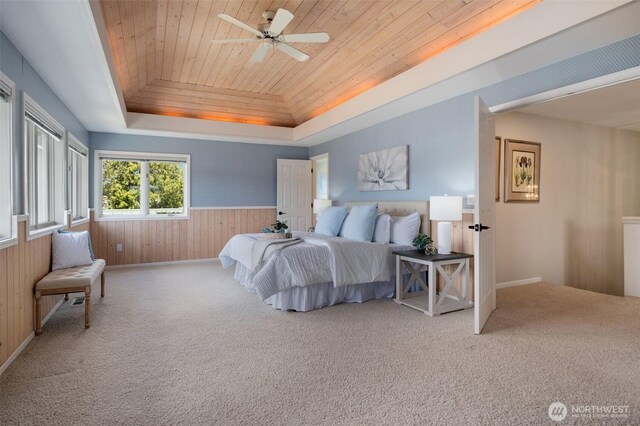 11521 E State Route 106, Union, WA 98592 - carpeted bedroom with a raised ceiling, wood ceiling, wood walls, a wainscoted wall, and baseboards