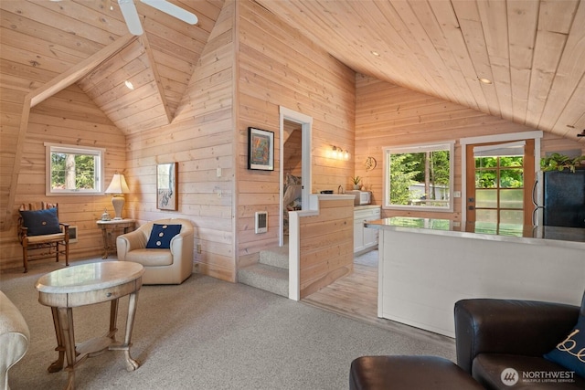 11521 E State Route 106, Union, WA 98592 - living area with vaulted ceiling, wood ceiling, light colored carpet, wood walls, and ceiling fan