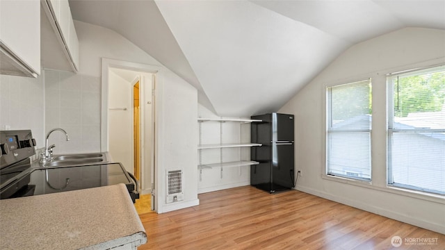 309 E Sumach St, Walla Walla, WA 99362 - kitchen with freestanding refrigerator, vaulted ceiling, a sink, light wood finished floors, and light countertops