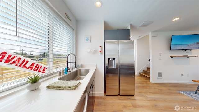 890 Magellan Ave NE Unit 2, Ocean Shores, WA 98569 - kitchen with stainless steel appliances, a sink, baseboards, light wood-type flooring, and recessed lighting