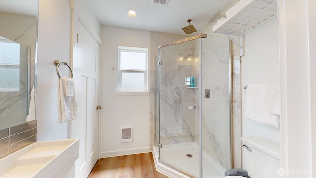 890 Magellan Ave NE Unit 2, Ocean Shores, WA 98569 - bathroom featuring a marble finish shower, toilet, wood finished floors, baseboards, and recessed lighting