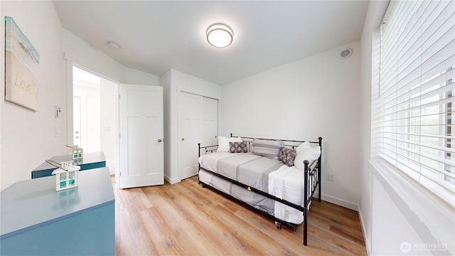 890 Magellan Ave NE Unit 2, Ocean Shores, WA 98569 - bedroom with light wood finished floors, a closet, and baseboards