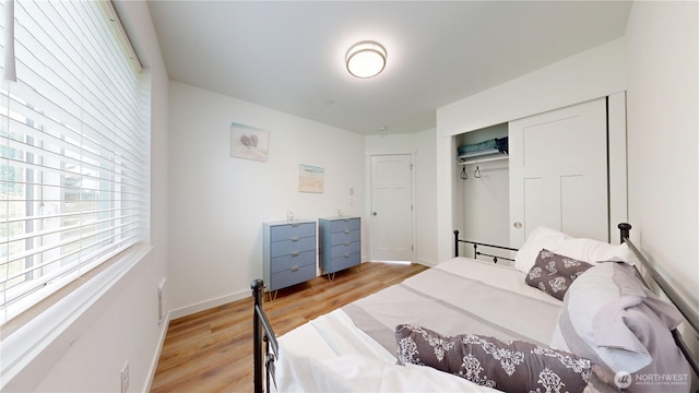 890 Magellan Ave NE Unit 2, Ocean Shores, WA 98569 - bedroom featuring light wood-type flooring, a closet, and baseboards