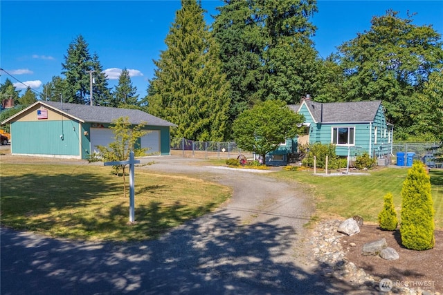 4211 108th Ave E, Edgewood, WA 98372 - view of front of house with an outdoor structure, driveway, a garage, and a chimney