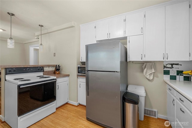 4211 108th Ave E, Edgewood, WA 98372 - kitchen with appliances with stainless steel finishes, white cabinets, light wood-type flooring, light countertops, and pendant lighting