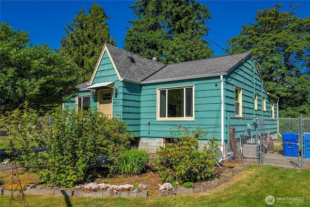 4211 108th Ave E, Edgewood, WA 98372 - view of home's exterior featuring a shingled roof and a gate