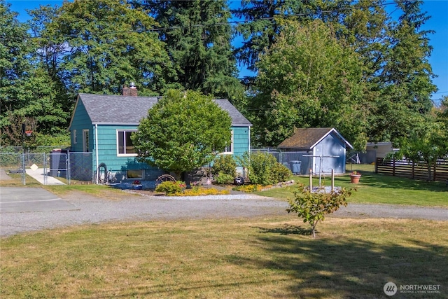 4211 108th Ave E, Edgewood, WA 98372 - view of front of home featuring a shingled roof, a chimney, and an outdoor structure