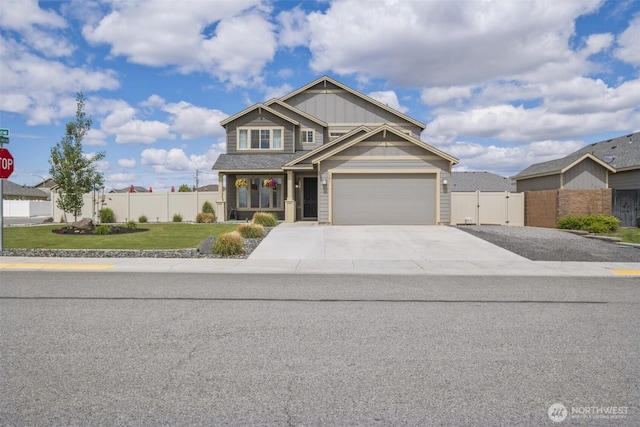 301 K St NE, Quincy, WA 98848 - craftsman house with a gate, concrete driveway, an attached garage, and board and batten siding