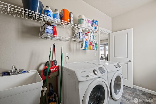 301 K St NE, Quincy, WA 98848 - washroom featuring washing machine and clothes dryer, baseboards, and stone finish flooring