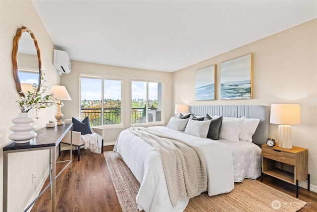 1965 12th Ave W Unit 202, Seattle, WA 98119 - bedroom with a wall unit AC, wood finished floors, and baseboards