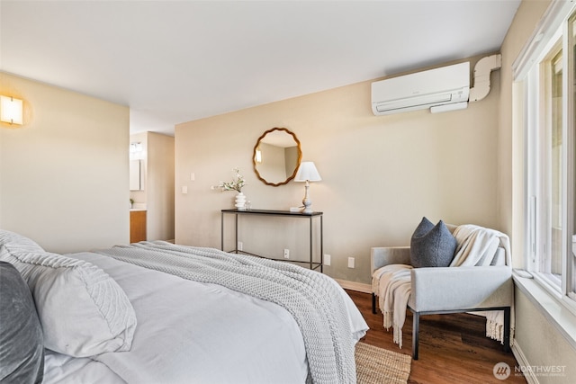 1965 12th Ave W Unit 202, Seattle, WA 98119 - bedroom with an AC wall unit, wood finished floors, and baseboards