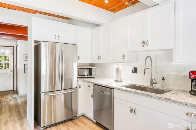11318 583rd Ave E, Enumclaw, WA 98022 - kitchen with stainless steel appliances, a sink, wooden ceiling with exposed beams, and white cabinets