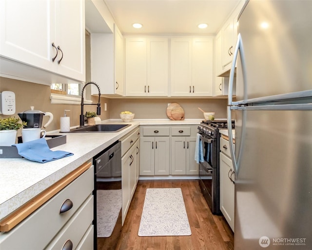 13812 Golden Given Rd E, Tacoma, WA 98445 - kitchen with freestanding refrigerator, dishwashing machine, gas range, a sink, and light countertops