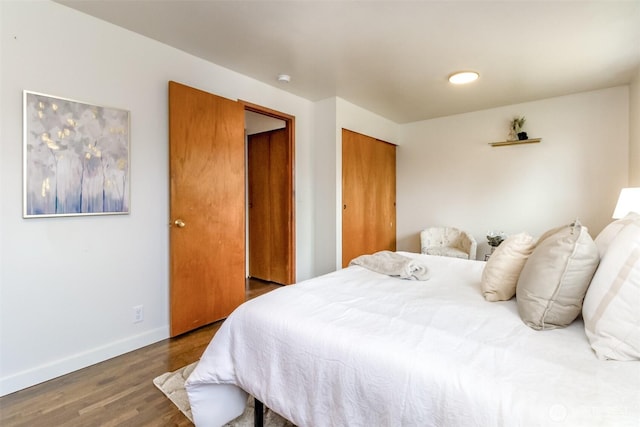 13812 Golden Given Rd E, Tacoma, WA 98445 - bedroom featuring wood finished floors, baseboards, and a closet