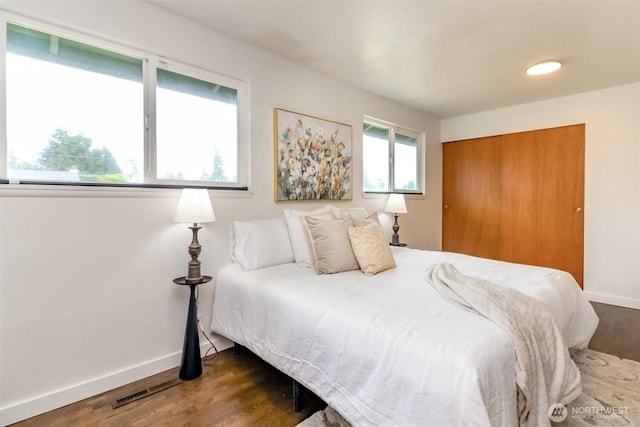 13812 Golden Given Rd E, Tacoma, WA 98445 - bedroom featuring wood finished floors, baseboards, and a closet
