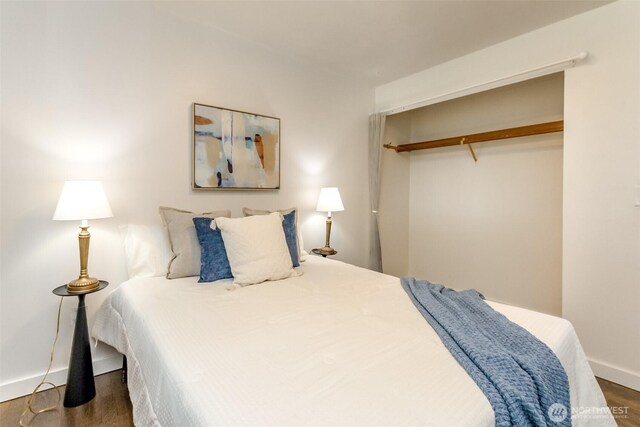 13812 Golden Given Rd E, Tacoma, WA 98445 - bedroom featuring wood finished floors, a closet, and baseboards