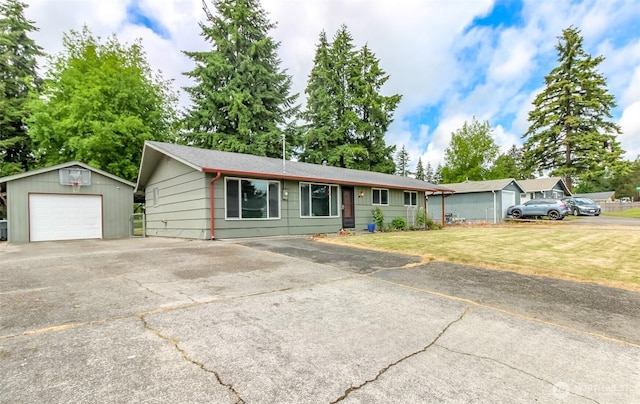 13812 Golden Given Rd E, Tacoma, WA 98445 - single story home with an outbuilding, a detached garage, driveway, and a front lawn