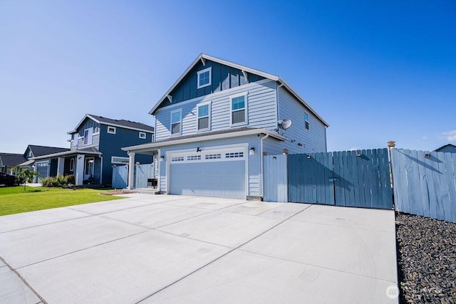 733 K St NE, Quincy, WA 98848 - view of front of property featuring board and batten siding, driveway, a garage, and a gate