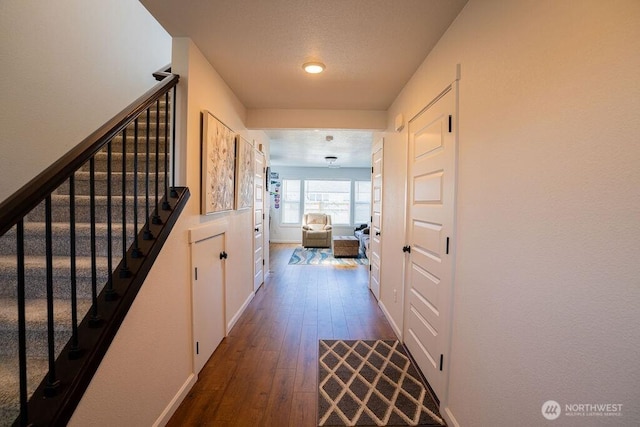 733 K St NE, Quincy, WA 98848 - hall featuring dark wood finished floors, stairs, and baseboards
