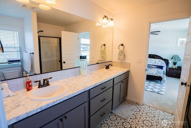 733 K St NE, Quincy, WA 98848 - ensuite bathroom with decorative backsplash, a stall shower, double vanity, and baseboards