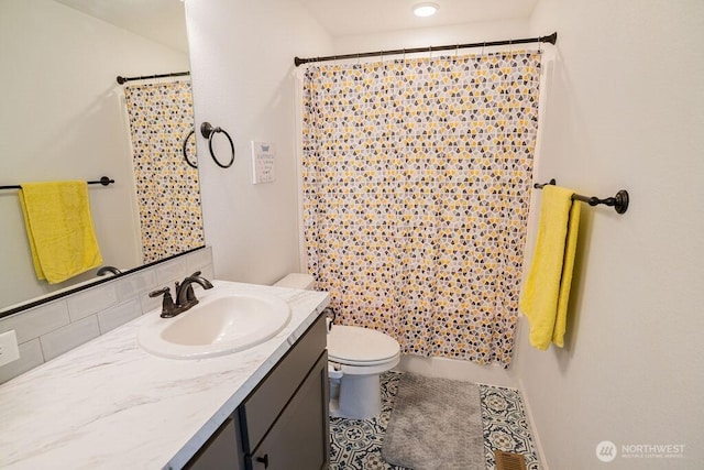 733 K St NE, Quincy, WA 98848 - bathroom featuring toilet, vanity, and backsplash