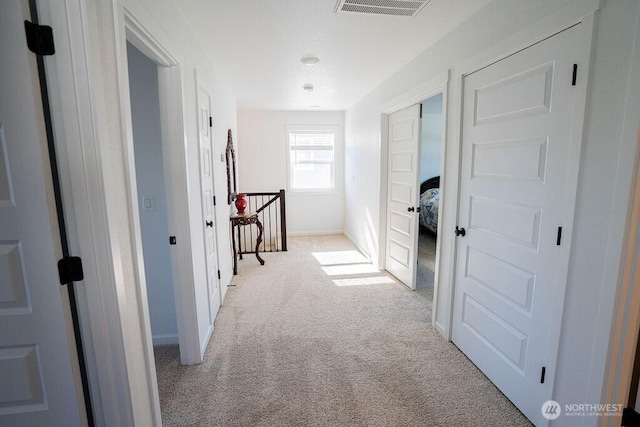 733 K St NE, Quincy, WA 98848 - corridor with light colored carpet, baseboards, and an upstairs landing