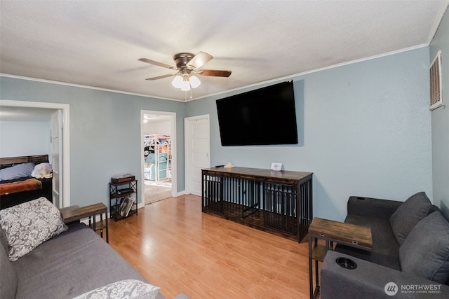 2395 SE Salmonberry Rd, Port Orchard, WA 98366 - living room featuring ornamental molding, ceiling fan, and light wood-style floors