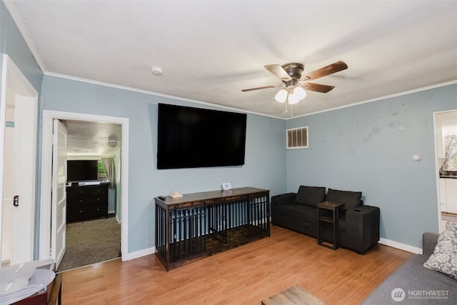 2395 SE Salmonberry Rd, Port Orchard, WA 98366 - living area featuring wood finished floors, a ceiling fan, ornamental molding, and baseboards