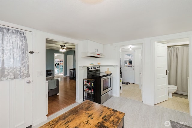 2395 SE Salmonberry Rd, Port Orchard, WA 98366 - kitchen featuring stainless steel range with electric cooktop, under cabinet range hood, ceiling fan, white cabinetry, and light wood-type flooring