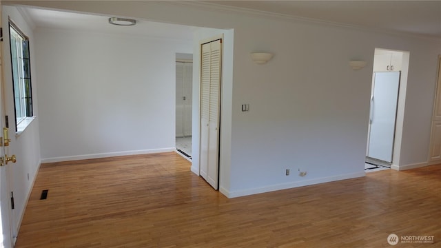 4635 N Defiance St, Tacoma, WA 98407 - unfurnished room with crown molding, light wood-style floors, and baseboards