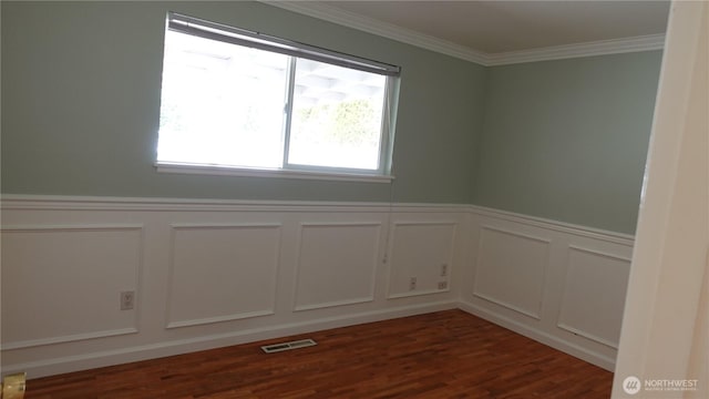 4635 N Defiance St, Tacoma, WA 98407 - empty room with a decorative wall, a wainscoted wall, ornamental molding, and dark wood finished floors