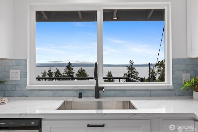 1345 Rainbow Ln, Camano Island, WA 98282 - kitchen featuring a sink, dishwashing machine, white cabinets, and backsplash
