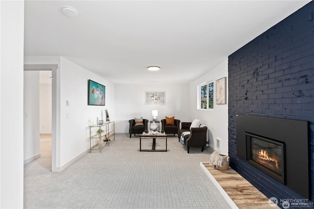 1345 Rainbow Ln, Camano Island, WA 98282 - living room featuring light colored carpet, a brick fireplace, and baseboards