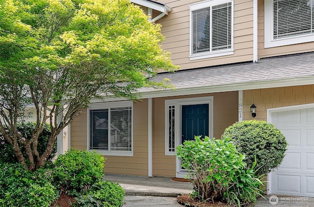 821 Sarah Ct NW, Olympia, WA 98502 - view of exterior entry with a shingled roof and an attached garage