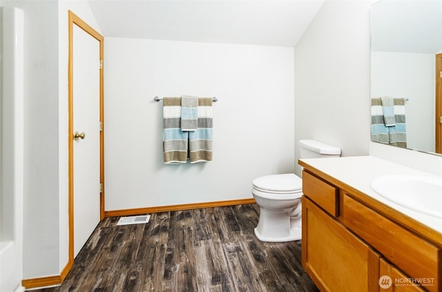 821 Sarah Ct NW, Olympia, WA 98502 - bathroom with vanity, wood finished floors, toilet, lofted ceiling, and baseboards