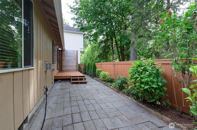 821 Sarah Ct NW, Olympia, WA 98502 - fenced backyard with a wooden deck and a patio area