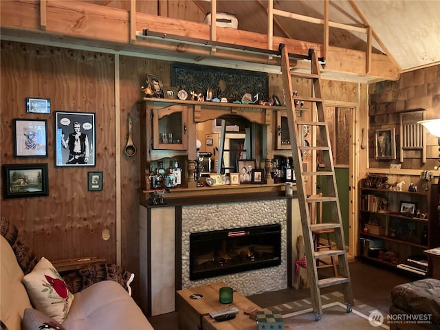 291 Williams Rd, Ariel, WA 98603 - living area featuring a glass covered fireplace, wood walls, and vaulted ceiling