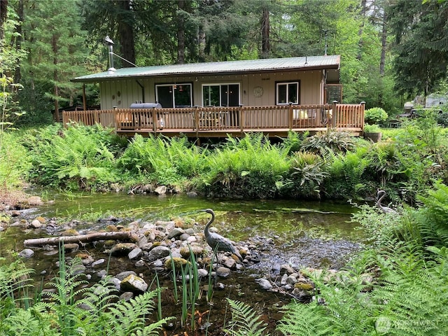 291 Williams Rd, Ariel, WA 98603 - view of front of home with a wooded view, board and batten siding, metal roof, and a deck