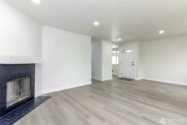 5611 S Cheyenne St, Tacoma, WA 98409 - unfurnished living room featuring a tile fireplace, recessed lighting, wood finished floors, and baseboards
