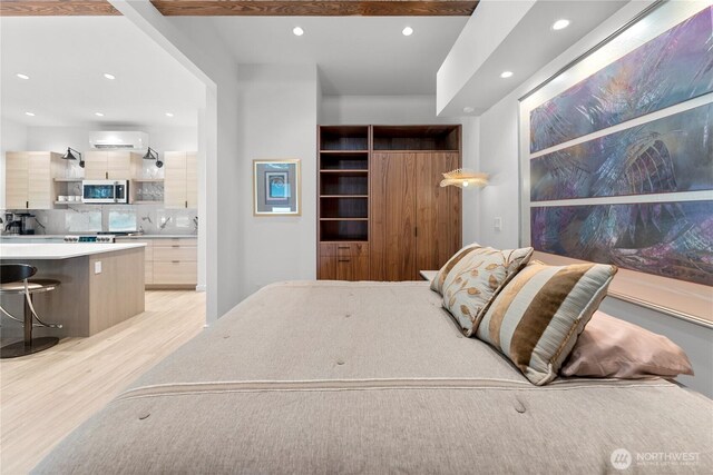 19 Davelaar Dr, Mazama, WA 98833 - bedroom with light wood-type flooring, recessed lighting, a wall mounted air conditioner, and connected bathroom