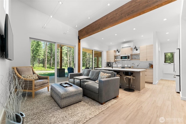 19 Davelaar Dr, Mazama, WA 98833 - living area with a wall unit AC, light wood-style flooring, recessed lighting, and beam ceiling